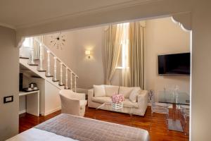 a living room with a couch and a chair at Les Fleurs Luxury House in Rome