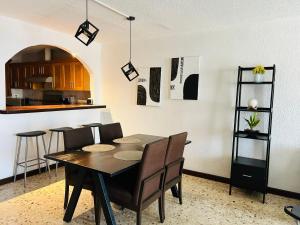 a kitchen and dining room with a table and chairs at Comfortable apartment 10 min BBVA Stadium - Wi-fi Parking SmartTV & AC in Monterrey