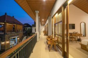 an indoor balcony with tables and chairs on a building at Amantra Ubud in Ubud