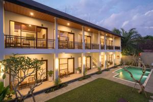 a villa with a swimming pool at night at Amantra Ubud in Ubud