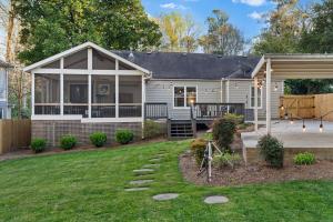 a white house with a porch and a yard at Private Compound in Decatur in Decatur