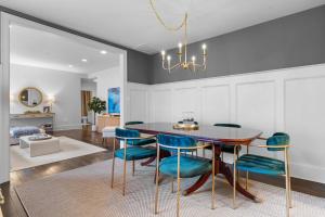 a dining room with a table and blue chairs at Private Compound in Decatur in Decatur