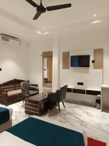 a living room with a couch and a tv at Rudram Inn in Varanasi