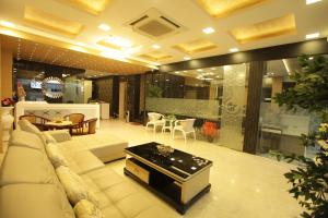 a large living room with a couch and a table at Grand Cascade Chennai in Chennai