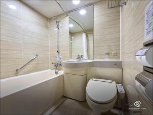 a bathroom with a toilet and a tub and a sink at Daiwa Roynet Hotel Hakata-Gion in Fukuoka +24 photos
