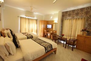 Postel nebo postele na pokoji v ubytování Grand Cascade Chennai + 37 fotografií