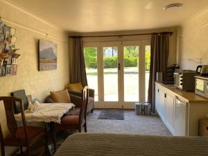 a room with a kitchen with a table and a tableablish at Pierrepoint Accommodation in Hamilton
