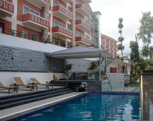 a pool in front of a building at Nagarjun Resort - Embrace Tranquility Natures Retreat Beyond the City in Kathmandu