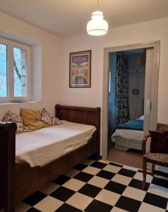 a bedroom with a bed with a checkered floor at Le gîte d'alfred in Prades