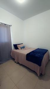 a bedroom with a bed in a white room at Candy House Marsella in Sitio Grande