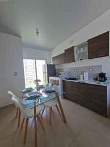 a kitchen with a table and chairs in a kitchen at Candy House Marsella in Sitio Grande