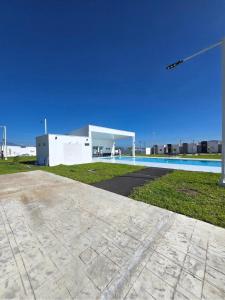 a building with a swimming pool in front of it at Candy House Marsella in Sitio Grande