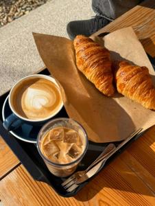 a tray with a cup of coffee and croissants on a table at soyeonjae 소연재 in Gyeongju