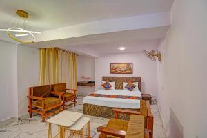 a hotel room with a bed and a table and chairs at FabHotel Shree Ji in Lucknow +38 photos