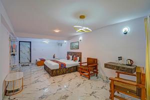 a bedroom with a bed and a desk in it at FabHotel Shree Ji in Lucknow