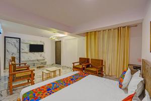 a hotel room with a bed and a tv at FabHotel Shree Ji in Lucknow