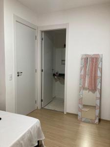 a white room with a bed and a closet at Hostel Vibes in Rio de Janeiro