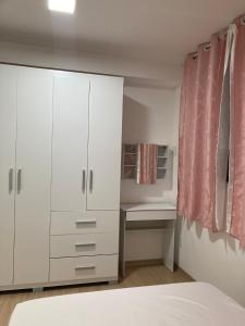 a bedroom with a white cabinet and a desk at Hostel Vibes in Rio de Janeiro