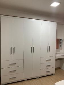 a white closet with white cabinets in a room at Hostel Vibes in Rio de Janeiro