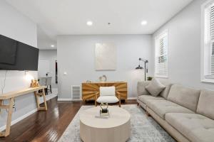 a living room with a couch and a table at Spacious 3BR 2BA Apt with Private Parking Walk to PATH in Jersey City