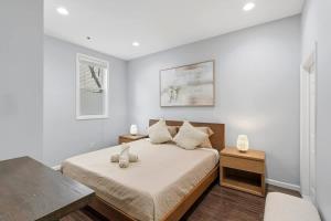 a bedroom with a large bed with white walls at Spacious 3BR 2BA Apt with Private Parking Walk to PATH in Jersey City
