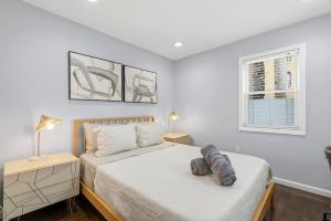 a bedroom with a bed and two lamps and a window at Spacious 3BR 2BA Apt with Private Parking Walk to PATH in Jersey City