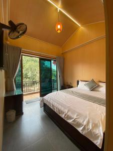 a bedroom with a bed and a large window at Your Home in Vũ Lâm