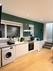 a kitchen with a washer and dryer in it at Autumn’s Retreat in Newcastle upon Tyne