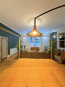 a bedroom with a large bed with a light fixture at Autumn’s Retreat in Newcastle upon Tyne