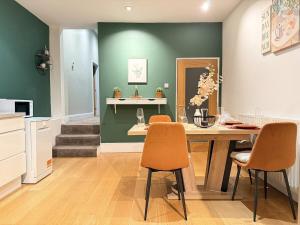 a dining room with a table and two chairs at Autumn’s Retreat in Newcastle upon Tyne