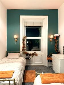 a bedroom with a bed and a window at Autumn’s Retreat in Newcastle upon Tyne +11 photos