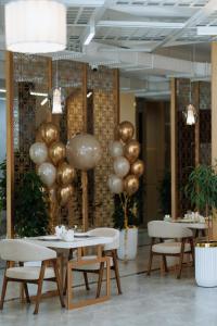 a room with balloons and a table and chairs at Grand Altyn Hotel in Shymkent