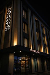 a building with a sign on the front of it at night at Grand Altyn Hotel in Shymkent