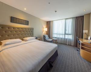 a hotel room with a large bed and a desk at Best Western Hotel Gunsan in Gunsan-si +31 photos