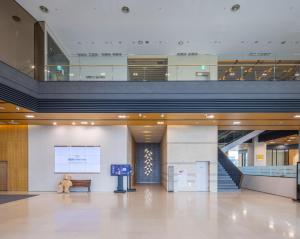a teddy bear sitting on a bench in a building at Best Western Hotel Gunsan in Gunsan-si