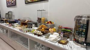 a buffet of food on a table in a restaurant at Horizon Haven Hotel in Urganch
