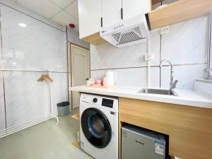 a kitchen with a washing machine and a sink at 利園賓館 in Hong Kong +37 photos