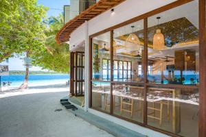 a building on the beach with a view of the ocean at Thundi by Biosphere in Maalhos