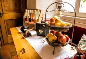 two baskets of fruit sitting on top of a table at Weingut Herrenhof Andrea Thielen in Minheim +6 photos