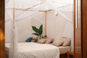 a bedroom with a bed with a canopy at Solara Arugam Bay in Arugam Bay