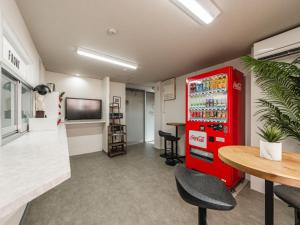 an office with a red refrigerator and a table at Hale Hotel Miyakojima in Miyako-jima