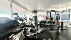 a fitness room with a gym with a treadmill at Sunset Plaza Condominium in Karon Beach