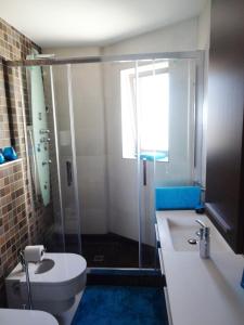 a bathroom with a shower and a toilet and a sink at Vista Bella Apartment in Calpe