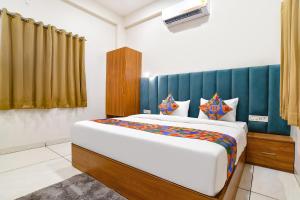 a bedroom with a large bed in a room at FabHotel Olive Inn in Indore