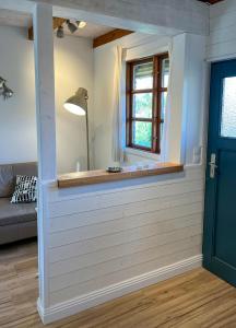 a room with a wall with a window and a door at Kleiner Anker in Fehmarn