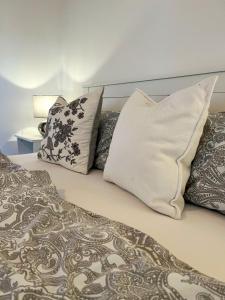 a bed with three pillows on top of it at Kleiner Anker in Fehmarn +16 photos