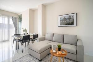 a living room with a couch and a table at Bustle Base Coliving and Coworking Space in Legian