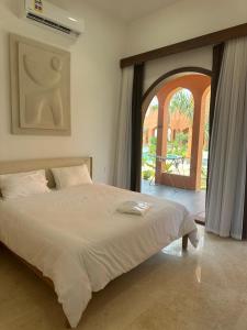 a bedroom with a large bed with an open door at Arabian Coral in Ḩaḑbaram +8 photos