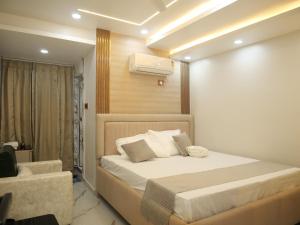 a bedroom with a bed and a air conditioner at Happy Residency in Patna
