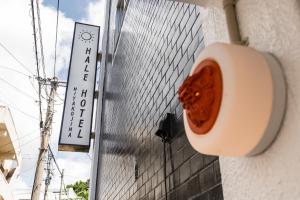 a red object is on the side of a building at Hale Hotel Miyakojima in Miyako-jima